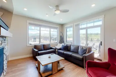 a living room with a couch and a table at Modern Mountain Getaway in Winter Park