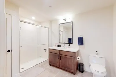 a bathroom with a toilet and a sink and a shower at Modern Mountain Getaway in Winter Park