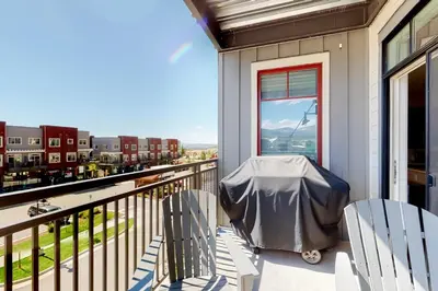 a balcony with two chairs and a view of the city at Modern Mountain Getaway in Winter Park