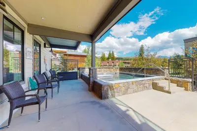 a patio with chairs and a swimming pool at Modern Mountain Getaway in Winter Park