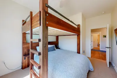 a bedroom with a wooden bunk bed with a ladder at Modern Mountain Getaway in Winter Park