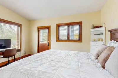 a bedroom with a large white bed and a television at Modern Grand Lake Luxury in Grand Lake