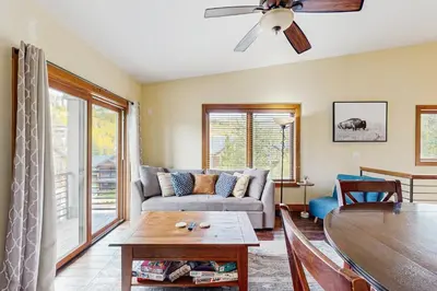 a living room with a couch and a table at Modern Grand Lake Luxury in Grand Lake