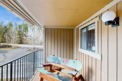 a bench on a porch with a skateboard on it at Rustic Relaxation in Winter Park in Winter Park