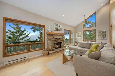 a living room with a couch and a fireplace at Cliffview Luxury Vacation Rental at Windcliff home in Estes Park