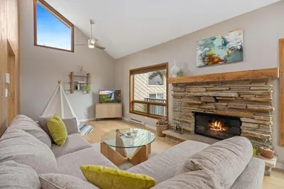 a living room with a couch and a fireplace at Cliffview Luxury Vacation Rental at Windcliff home in Estes Park