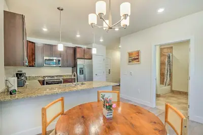 a kitchen and dining room with a wooden table and chairs at Condo 2 Mi to Keystone Resort Relax Fireside! in Keystone