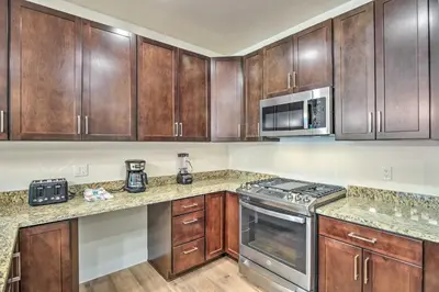 a kitchen with wooden cabinets and stainless steel appliances at Condo 2 Mi to Keystone Resort Relax Fireside! in Keystone