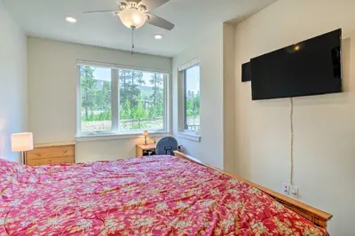 a bedroom with a large bed and a flat screen tv at Condo 2 Mi to Keystone Resort Relax Fireside! in Keystone