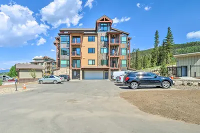 a large building with cars parked in a parking lot at Condo 2 Mi to Keystone Resort Relax Fireside! in Keystone