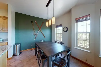 a kitchen with a table and chairs in a room at Summer's End in Granby
