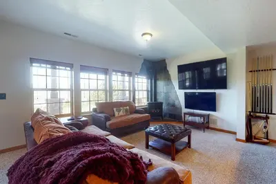 a living room with a couch and a tv at Summer's End in Granby