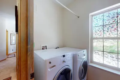 a washing machine in a laundry room with a window at Summer's End in Granby