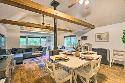 a living room with a table and chairs at Creekside Morrison Cabin about 9 Mi to Red Rocks Park! in Morrison