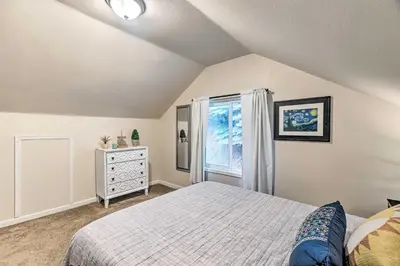 a bedroom with a bed and a window at Creekside Morrison Cabin about 9 Mi to Red Rocks Park! in Morrison