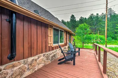 a wooden deck with a bench on the side of a house at Creekside Morrison Cabin about 9 Mi to Red Rocks Park! in Morrison