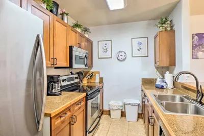 a kitchen with wooden cabinets and a stainless steel refrigerator at Less Than 1 Mi to Slopes Mtn-View Keystone Condo in Dillon