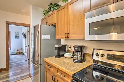 a kitchen with stainless steel appliances and wooden cabinets at Less Than 1 Mi to Slopes Mtn-View Keystone Condo in Dillon