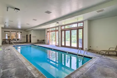 a large swimming pool with blue water in a building at Less Than 1 Mi to Slopes Mtn-View Keystone Condo in Dillon