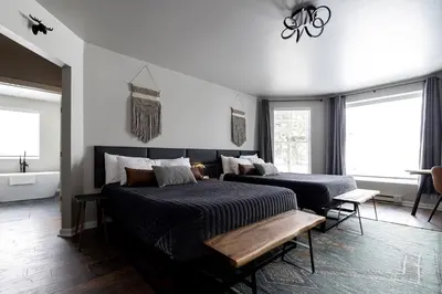 a bedroom with two beds and a bath tub at Winter Park Chateau in Winter Park