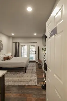 a bedroom with a bed and a tv and a door at Winter Park Chateau in Winter Park