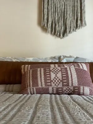 a bed with a pillow on top of it at Winter Park Chateau in Winter Park