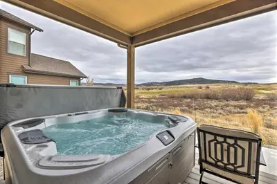 a hot tub on the deck of a house at 3 Mi to Granby Ranch Home with Hot Tub and Mtn Views! in Granby