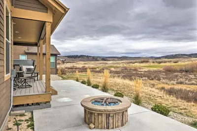 a patio with a fire pit on the side of a house at 3 Mi to Granby Ranch Home with Hot Tub and Mtn Views! in Granby