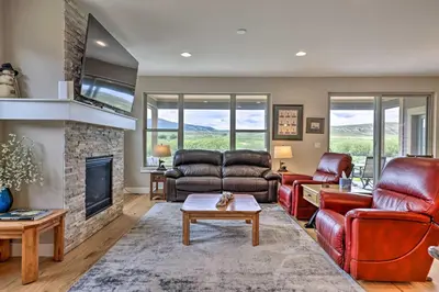 a living room with leather furniture and a fireplace at 3 Mi to Granby Ranch Home with Hot Tub and Mtn Views! in Granby