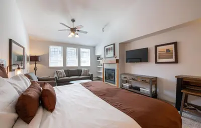 a bedroom with a large bed and a tv at Premium Unit 3620 - Studio - Fraser Crossing Founders Pointe condo in Winter Park