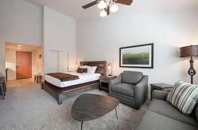 a hotel room with a bed and a couch and chair at Premium Unit 3620 - Studio - Fraser Crossing Founders Pointe condo in Winter Park