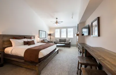 a bedroom with a bed and a living room at Premium Unit 3620 - Studio - Fraser Crossing Founders Pointe condo in Winter Park