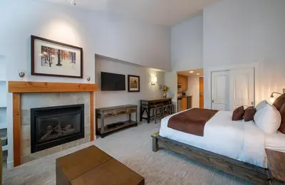 a hotel room with a bed and a fireplace at Premium Unit 3620 - Studio - Fraser Crossing Founders Pointe condo in Winter Park