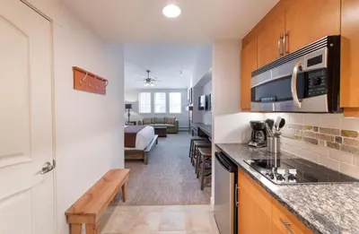 a kitchen with a counter and a living room at Premium Unit 3620 - Studio - Fraser Crossing Founders Pointe condo in Winter Park