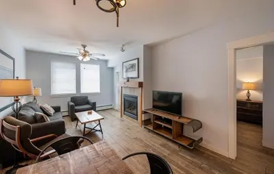 a living room with a couch and a television at Premium Unit 4568 - One Bedroom withKitchenette - Fraser Crossing Founders Pointe condo in Winter Park