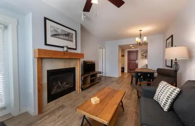 a living room with a fireplace and a couch at Premium Unit 4568 - One Bedroom withKitchenette - Fraser Crossing Founders Pointe condo in Winter Park