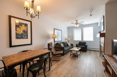 a living room with a table and a couch at Premium Unit 4568 - One Bedroom withKitchenette - Fraser Crossing Founders Pointe condo in Winter Park