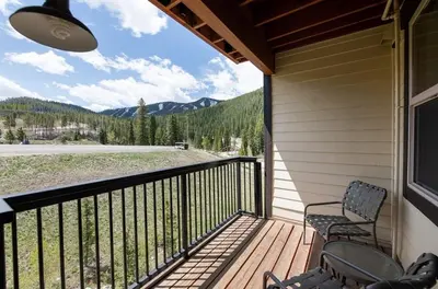 a porch with two chairs and a view of the mountains at Premium Unit 4568 - One Bedroom withKitchenette - Fraser Crossing Founders Pointe condo in Winter Park