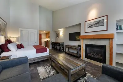 a hotel room with a bed and a fireplace at Premium Unit 4667 - Studio - Fraser Crossing Founders Pointe condo in Winter Park