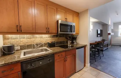 a kitchen with a sink and a microwave at Premium Unit 4667 - Studio - Fraser Crossing Founders Pointe condo in Winter Park