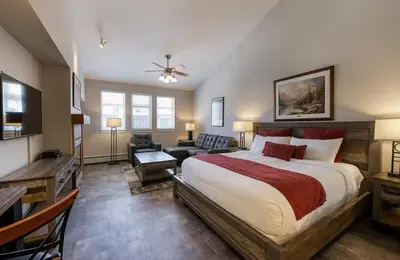 a bedroom with a large bed and a living room at Premium Unit 4667 - Studio - Fraser Crossing Founders Pointe condo in Winter Park