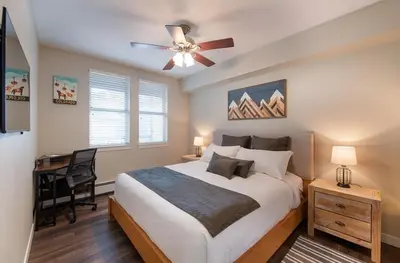 a bedroom with a bed with a ceiling fan and a desk at Premium Unit 4547 - One Bedroom withKitchenette - Fraser Crossing Founders Pointe condo in Winter Park