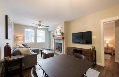 a living room with a couch and a table and a television at Premium Unit 4547 - One Bedroom withKitchenette - Fraser Crossing Founders Pointe condo in Winter Park