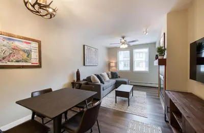 a living room with a table and a couch at Premium Unit 4547 - One Bedroom withKitchenette - Fraser Crossing Founders Pointe condo in Winter Park