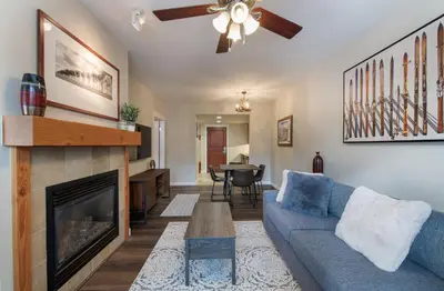 a living room with a blue couch and a fireplace at Premium Unit 4547 - One Bedroom withKitchenette - Fraser Crossing Founders Pointe condo in Winter Park
