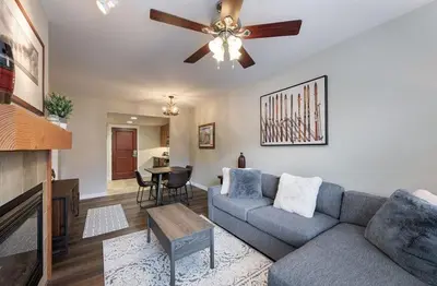 a living room with a couch and a ceiling fan at Premium Unit 4547 - One Bedroom withKitchenette - Fraser Crossing Founders Pointe condo in Winter Park