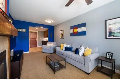 a living room with a couch and a tv at Premium Unit 4466 - One Bedroom withKitchenette - Fraser Crossing Founders Pointe condo in Winter Park
