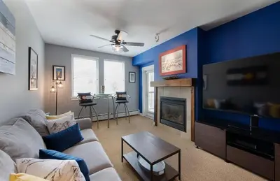 a living room with a couch and a fire place at Premium Unit 4466 - One Bedroom withKitchenette - Fraser Crossing Founders Pointe condo in Winter Park