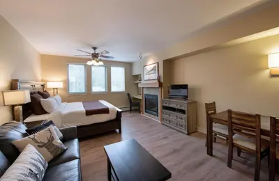 a living room with a bed a couch and a tv at Winter Park FF Premium-Rated 4443 in Winter Park