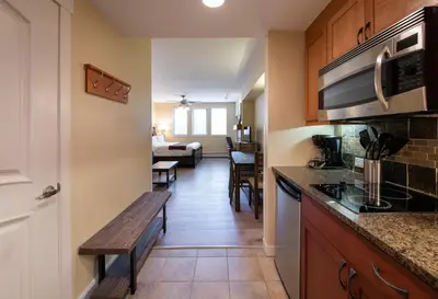 a kitchen with a bench and a living room at Winter Park FF Premium-Rated 4443 in Winter Park
